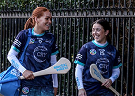 Two young women Camogie players smiling